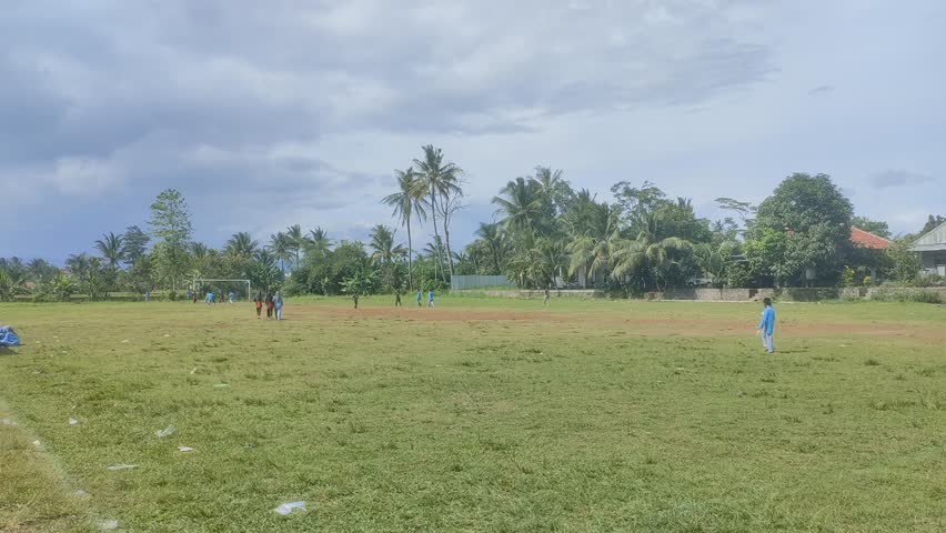 A lush green soccer field in the village serves as a popular playground for local kids to run, play and hone their football skills.