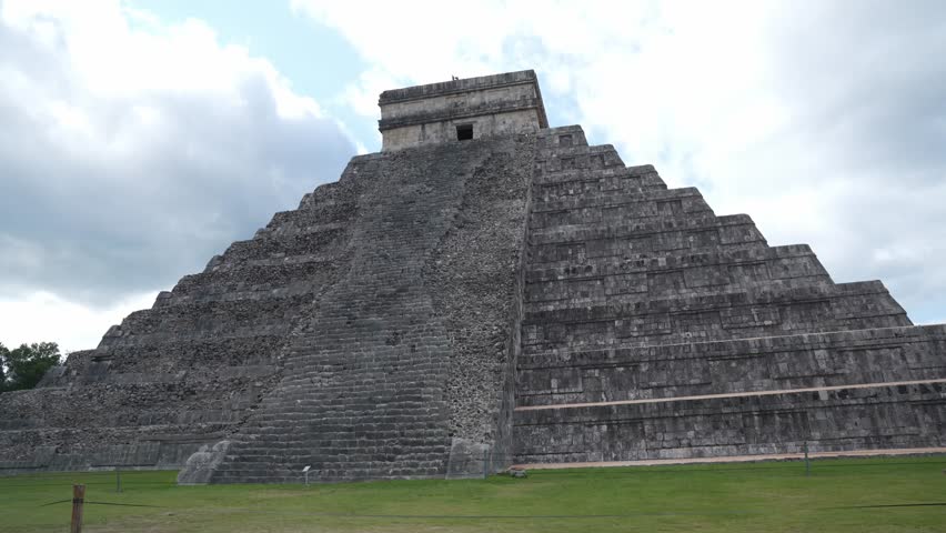Stunning view of El Castillo, the iconic step-pyramid at Chicehn Itza, a UNESCO World Heritage Site and ancient Mayan temple in Mexcio