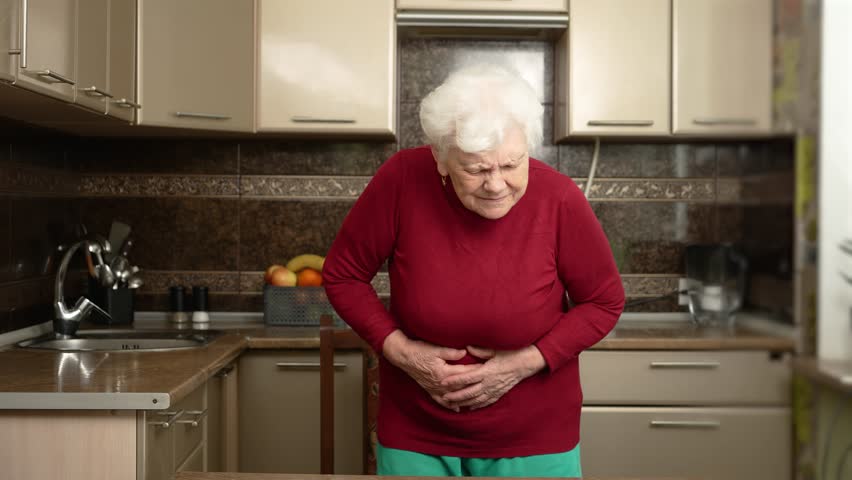 Stomach pain, hysteria. Senior woman with abdominal pain and suffers, feeling unwell physical or mental pain. Elderly woman in despair having gastrointestinal pain, panic or severe stress and