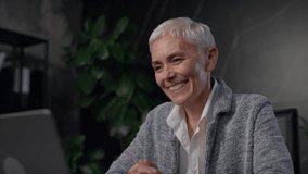 Smiling senior businesswoman in video call on laptop - Powered by Shutterstock - Get 15% off with code: PIKWIZARD15