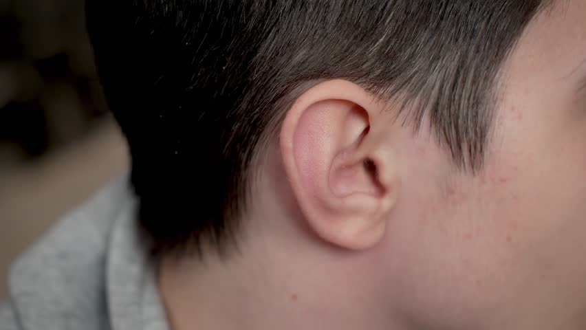 Close up teenage boy ear. Detailed shot young man fear. Close up adolescent boy ear