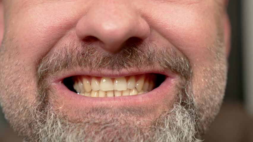 Man with mouth open and teeth visible moving jaw. Male with open mouth and visible teeth, shifting jaw. Guy opening mouth and moving his jaw, showing teeth