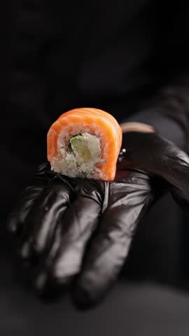 chef prepares delicious Japanese rolls