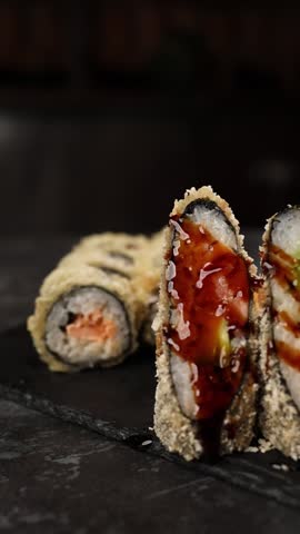chef prepares delicious Japanese rolls