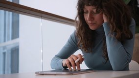 Professional graphic designer drawing on digital tablet, focusing intently while working in bright, modern office space with natural illumination and minimalist surroundings - Powered by Shutterstock - Get 15% off with code: PIKWIZARD15