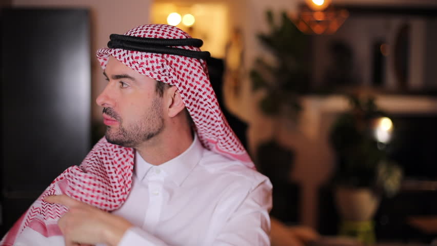 Very handsome Arabic man organizing his turban 