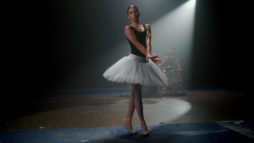 Classic ballet dance in studio with playing drummer, contemporary choreography. Contrast of arts, woman and man creating new style of dance and music, unique dance show with ballerina and rock star