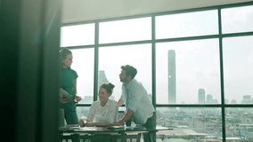 Group of happy skilled businesspeople discuss, brainstorming, sharing idea, plan, strategy about financial statistic on meeting table with laptop and statistic document. Cityscape view. Tracery - Powered by Shutterstock - Get 15% off with code: PIKWIZARD15