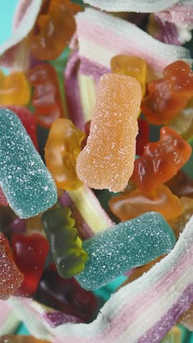 Colorful gummy candies and sour strips in a vibrant mix