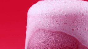 Bright pink foamy fruit cherry beer pouring down into the glass close up - Powered by Shutterstock - Get 15% off with code: PIKWIZARD15