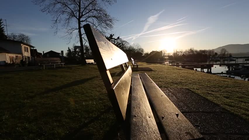 Bench and sunrise at a Lake Geneva shore park.