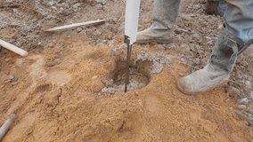 A dedicated worker is conducting soil sampling for preparations for upcoming construction activities - Powered by Shutterstock - Get 15% off with code: PIKWIZARD15