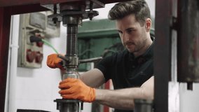 Technician operating industrial machinery in workshop - Powered by Shutterstock - Get 15% off with code: PIKWIZARD15