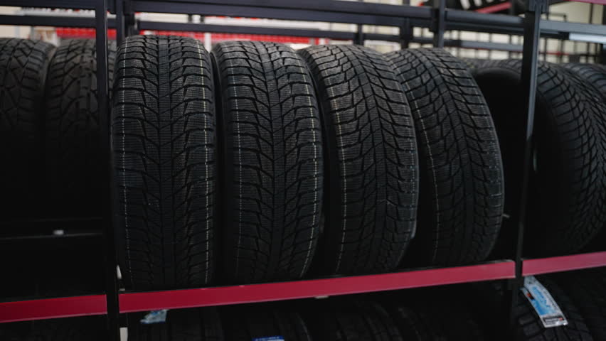 Close-up of new tires on store shelves in auto shop