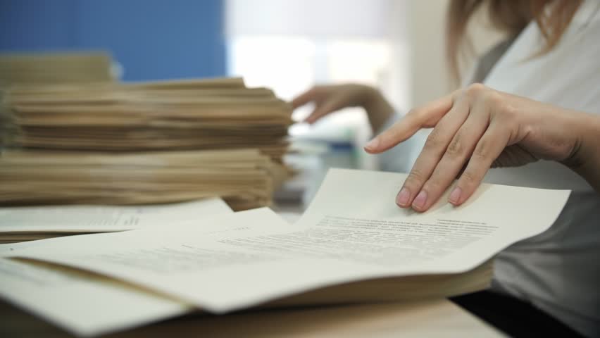 Office Worker Sorting Paper Documents