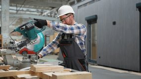 Carpenter cutting wood at modular home manufacturing site - Powered by Shutterstock - Get 15% off with code: PIKWIZARD15