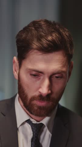 Young satisfied businessman adult returning home from hard day in the office untying necktie feel free relaxing. Caucasian handsome executive. Apartment.