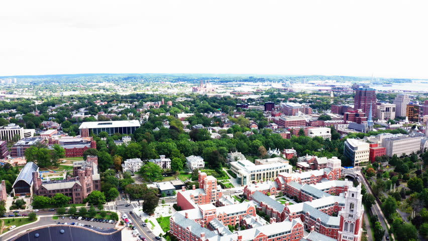 Fly-out drone view of New Haven, Connecticut, capturing the city’s architectural blend and vibrant greenery from a stunning aerial perspective.