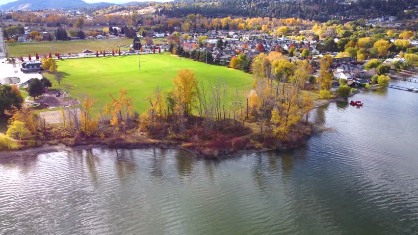 Lake Reflections, Fall Season Autumn Colours. Colourful Fall Leaves on Trees. Wood Lake, Lakecountry, BC, Okanagan Valley, British Columbia, Canada. Wide Landscape Beasley Park Sports Soccer Fields