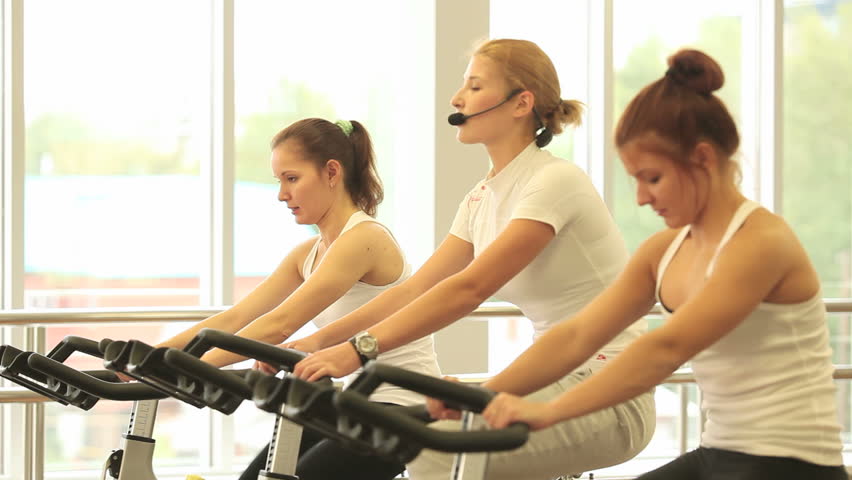 Group of women doing sport spinning in the gym