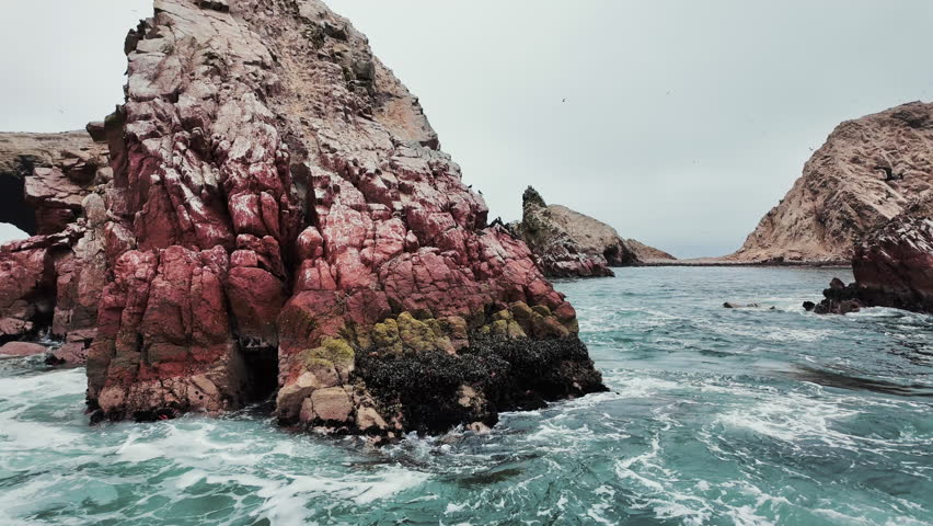 Misty, overcast views of the stunning Ballestas Islands National Reserve in Peru, surrounded by the vast Pacific Ocean.