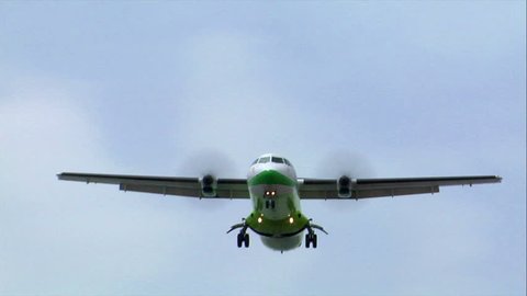green white turbo prop plane fly over - no visible signs or numbers. 10472
