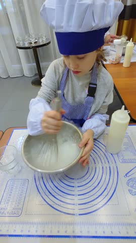 The girl are preparing food. Master class for children in culinary school. Children make ice cream. Culinary education. Dry ice. 