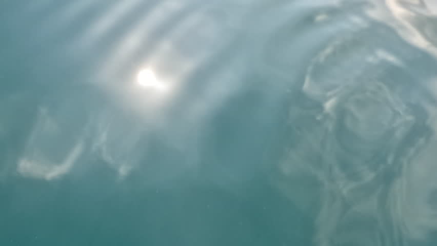 Water, Ripples, Sunlight - Close-up of calm water with ripples and sunlight reflection.