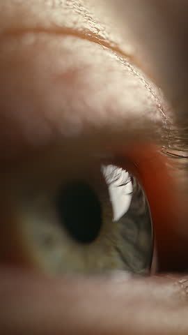 Vertical video of Human eye movement, opening and blinking of a male eye with blue iris, close up macro shot. Waking time and life-changing moment concepts.