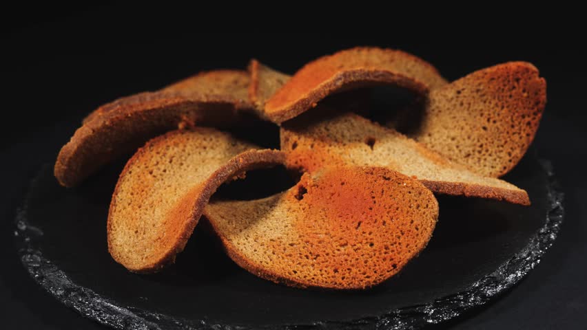 Rye bread crackers in spices on dark background, Beer snack,