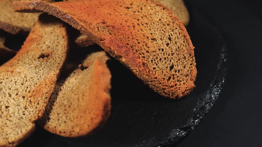 Rye bread crackers in spices on dark background, Beer snack,