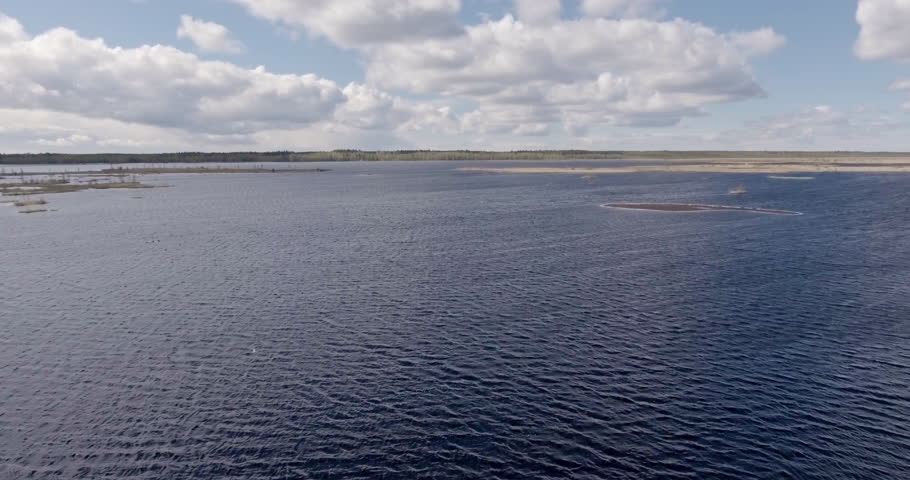 Drone Reversing Over a Lake with Gulls in the Distance - Low Altitude, Scenic Spring Landscape
