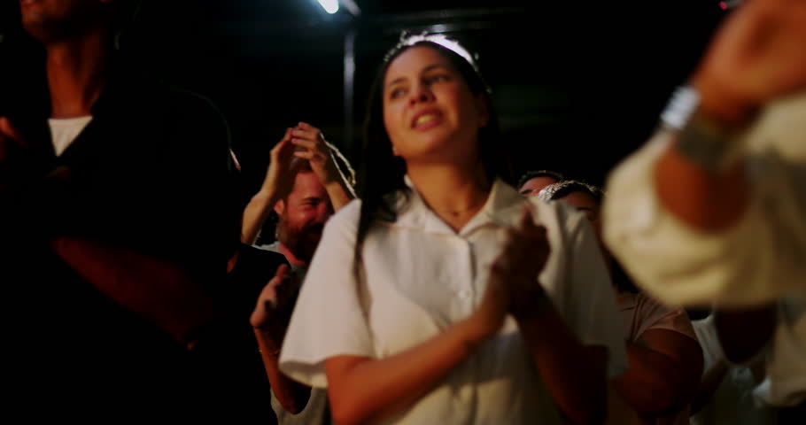 Congregants applauding in spiritual unity, mixed group of people celebrating faith during evangelical church service, hands clapping, expressions of worship and devotion