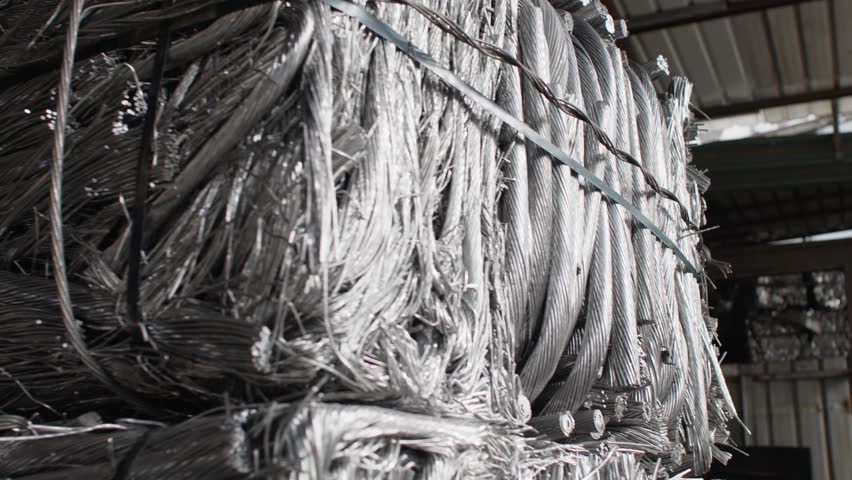 A stack of tightly bound metal scrap wire in a factory, symbolizing recycling efforts