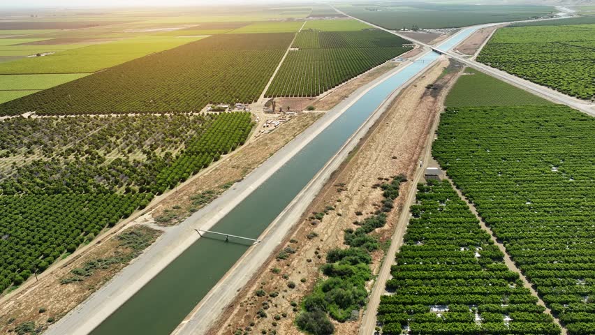 Aerial of farms along an aqueduct running through California's Central Valley north of Los Angeles.