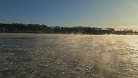 A tranquil icy winter morning scene featuring a foggy sunrise over the frozen lake, North America, Quebec, Montreal, Canada. - Powered by Shutterstock - Get 15% off with code: PIKWIZARD15