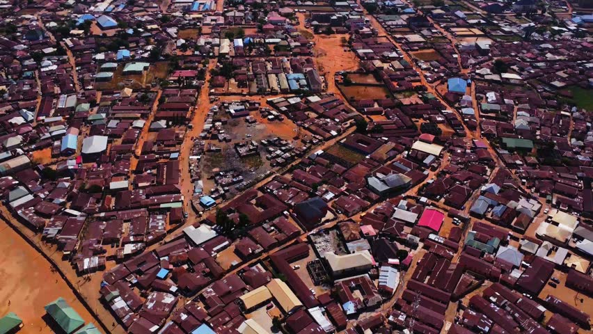 Jib down of Abuja slums with impoverished homes with metal rooftops in Nigeria, Africa.