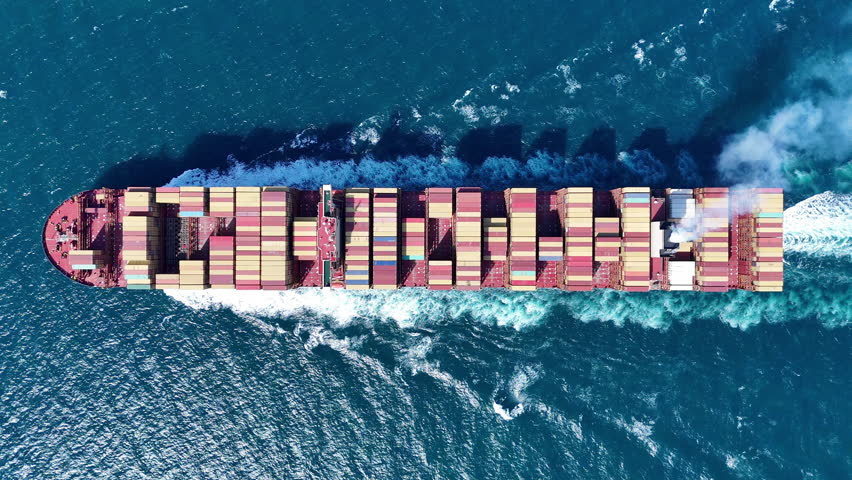 Cargo container ship carrying container and running in the ocean near international container port customs shipyard sea port concept smart logistic service. transportation logistics trading. top view