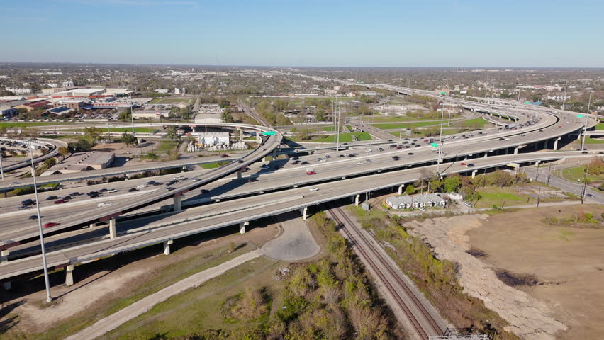 Stunning aerial view of Houstons downtown interchange area reveals a breathtaking perspective, showcasing the intricate highways, diverse urban landscape, vibrant city life thats bustling below