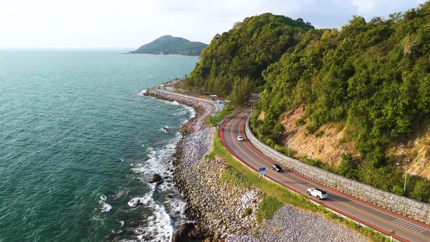 Experience the stunning beauty of Chantaburis coastal highway, where the road hugs the shoreline, offering spectacular ocean views and lush green hills. Its a perfect escape into nature of Thailand
