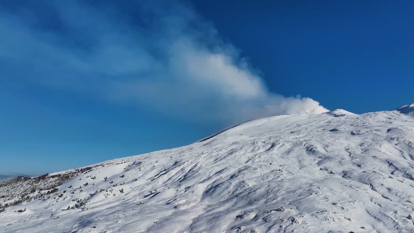 Shot during a snowfall in the tourist area of ​​Etna Sud on the Etna volcano. Snow-covered woods, Piano Vetore, Sapienza Refuge. Frozen cottage. Frozen trees. Snow storm.