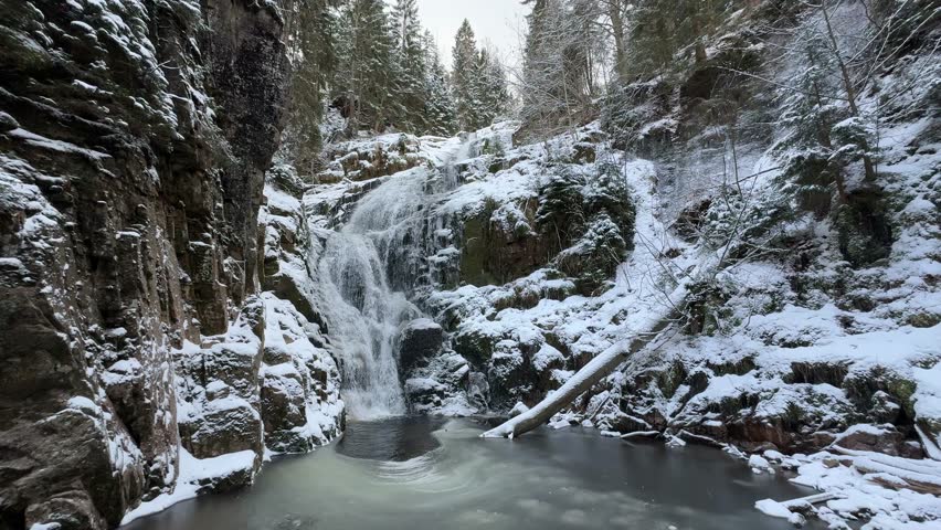 The scenic Kamienczyk Waterfall on the Karkonosze Mountains during winter season in Szklarska Poreba, Poland