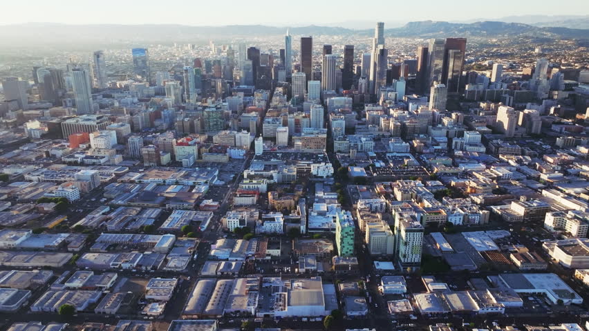 An aerial footage of the urban skyline and cityscape of Los Angeles, on a bright sunny day in California, USA