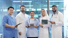 Portrait of group of smiling doctors standing in hospital clinic office looking at camera. Team of confident medical workers professionals in coats, showcasing healthcare, teamwork and modern medicine - Powered by Shutterstock - Get 15% off with code: PIKWIZARD15