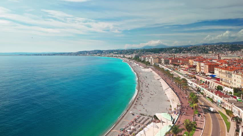 Beautiful view of Nice, Cote d'Azur, France. Panoramic cityscape of Nice on a sunny summer day, French Riviera. Top view of the iconic Baie des Anges and the Mediterranean Sea. Slow panning
