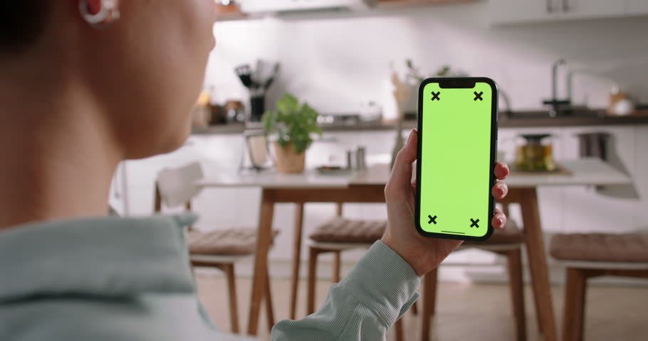 Unknown woman holds smartphone with chroma key screen mock-up. Tap at bottom of screen, buy online, submit applications, order taxis, make video calls interacts app, modern technology, app advertising