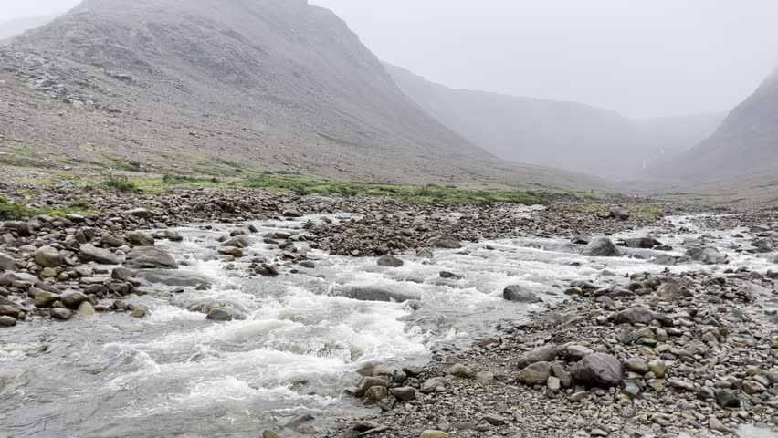The river flows alongside the hiking trail at the Tablelands in Gros Morne National Park, Newfoundland and Labrador, Canada.