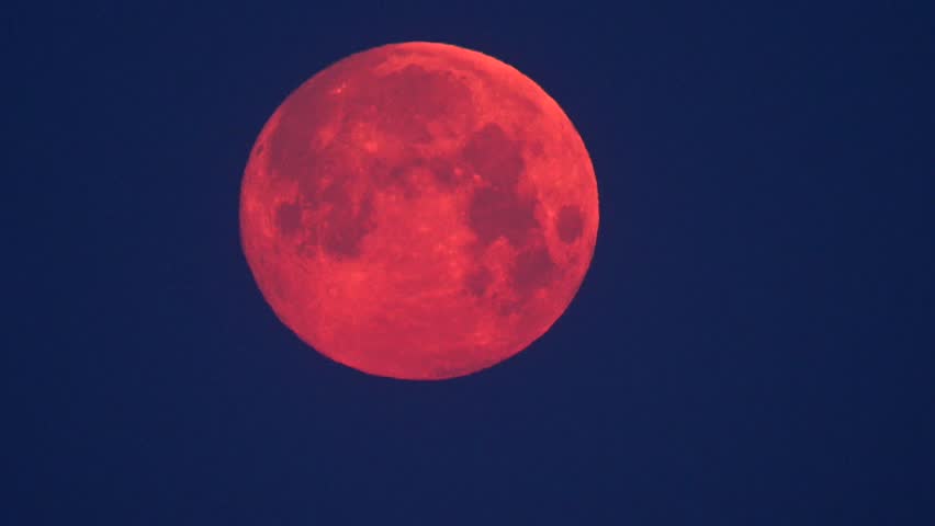 Stunning blood moon illuminates the night sky over a tranquil landscape