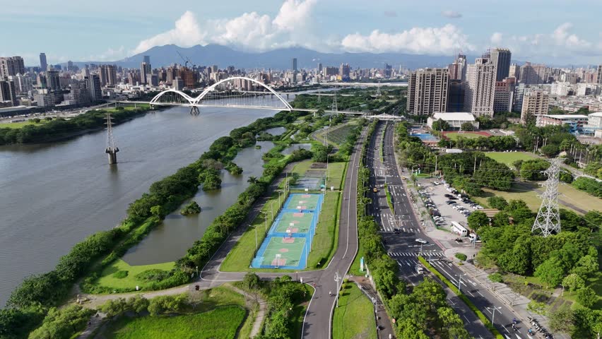 Aerial view on a beautiful sunny day above Crescent Bridge, which is a landmark pedestrian and cyclist bridge spanning Dahan river between Banqiao and Xinzhuang Districts in New Taipei City, Taiwan