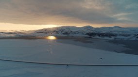 Aerial establishing above of Arctic snowfields reflecting warm evening light under clear skies - Powered by Shutterstock - Get 15% off with code: PIKWIZARD15